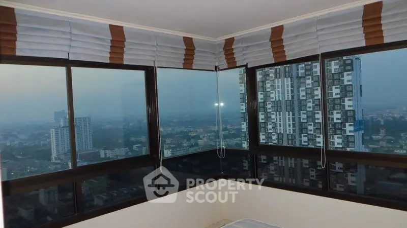 Stunning corner unit with panoramic city views from high-rise windows.