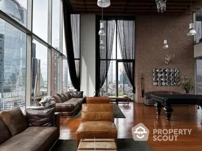 Luxurious high-rise living room with stunning city views and elegant leather furnishings.