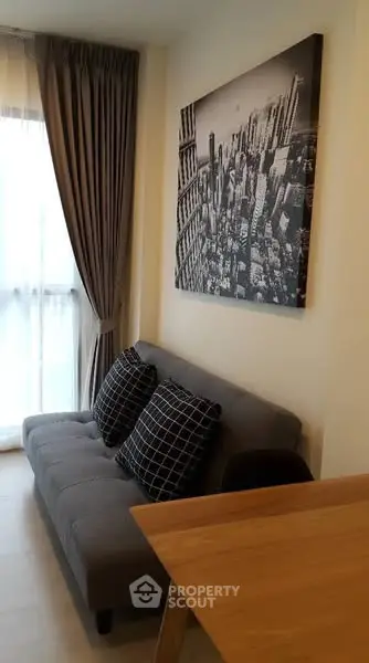 Modern living room with stylish sofa and cityscape artwork, perfect for urban living.