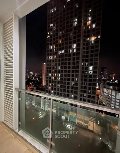 Stunning city view from high-rise balcony at night