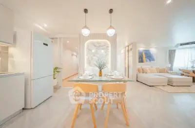 Spacious open-plan living room with modern kitchen and elegant dining area, perfect for entertaining.
