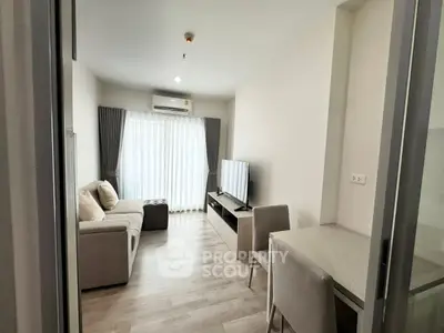 Modern living room with sleek furniture and natural light, perfect for cozy urban living.