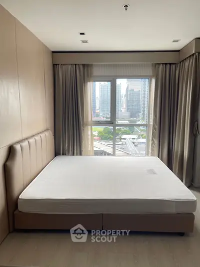 Spacious bedroom with city view and elegant decor in modern apartment