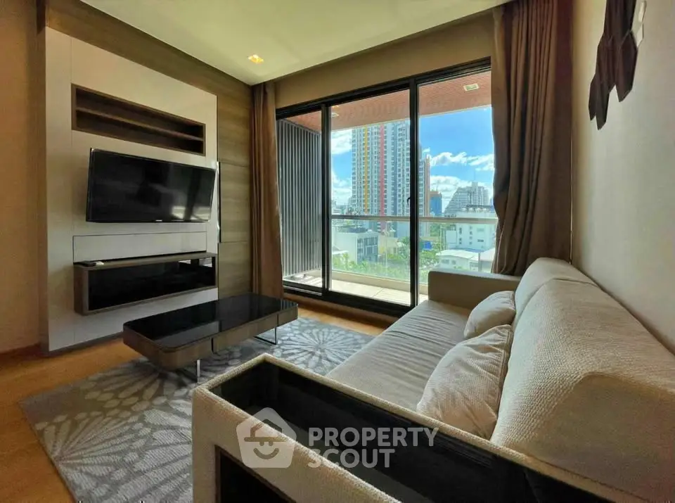 Modern living room with large window and city view, featuring a cozy sofa and wall-mounted TV.