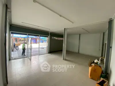 Spacious commercial space with large glass windows in a bustling area, ideal for retail or office use.