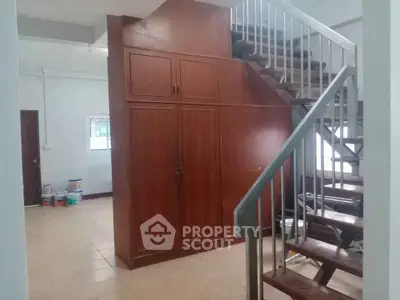 Spacious interior with wooden staircase and built-in storage, ideal for modern living.