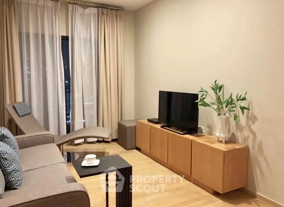 Modern living room with sleek furniture and natural light, perfect for relaxation and entertainment.
