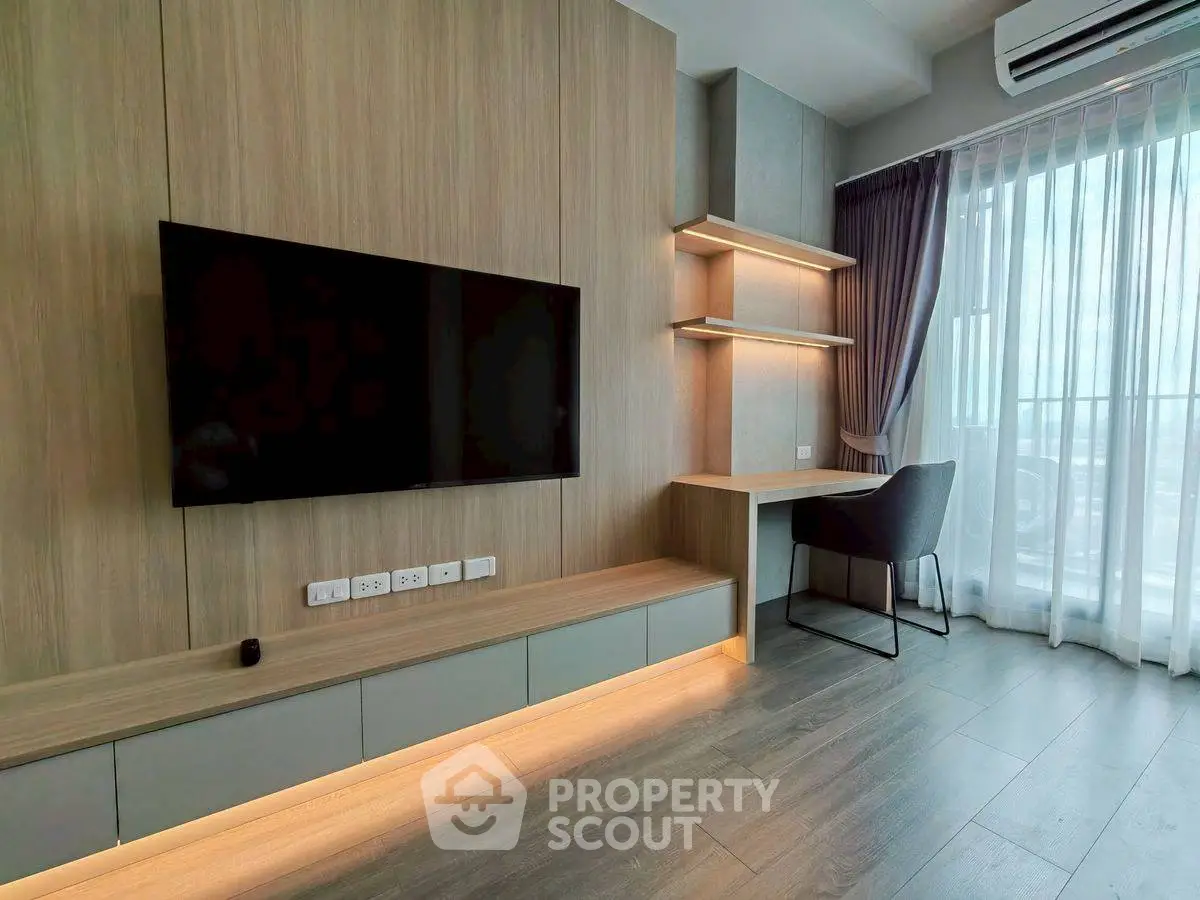 Modern living room with sleek TV setup and stylish study corner