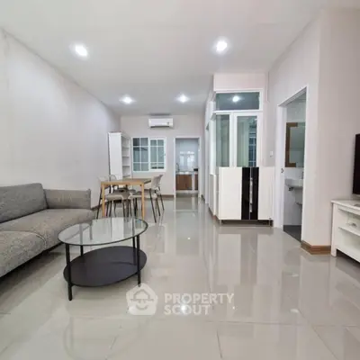 Spacious modern living room with sleek furniture and glossy tiled flooring
