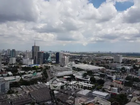 Stunning cityscape view showcasing urban skyline and expansive horizon under a cloudy sky.