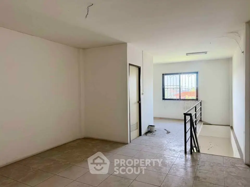 Spacious interior with tiled flooring and natural light, ideal for customization.