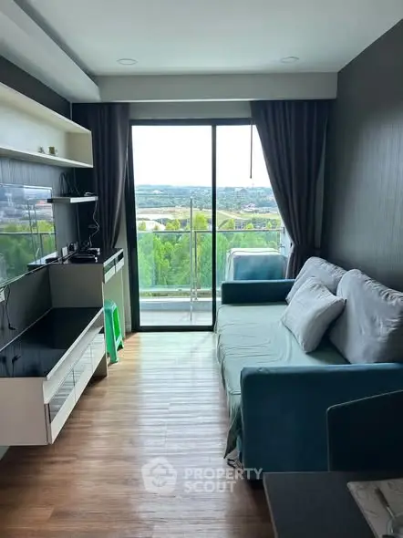 Modern living room with balcony and scenic view, featuring stylish furniture and natural light.
