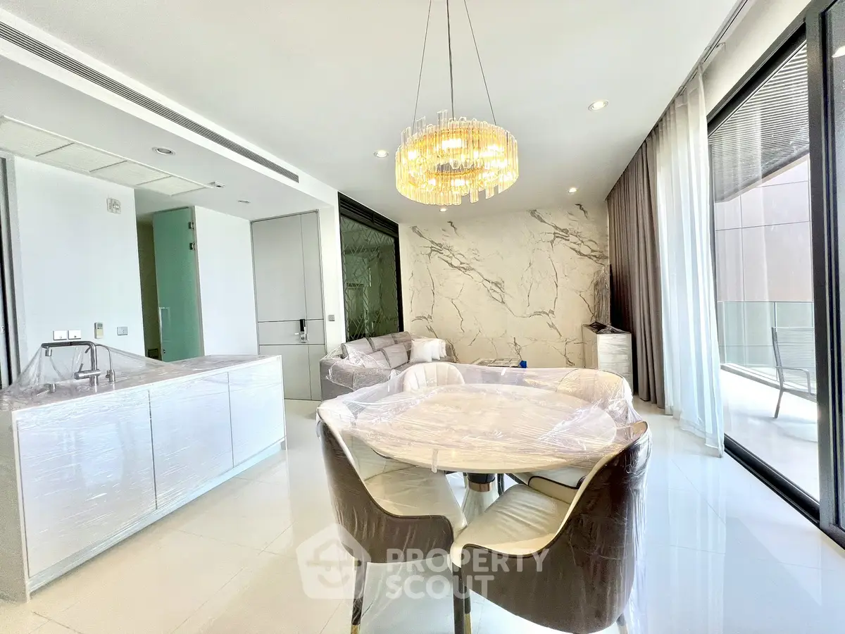 Luxurious modern living room with elegant chandelier and marble accents