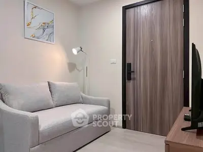 Cozy living room with modern sofa and stylish decor in a contemporary apartment.