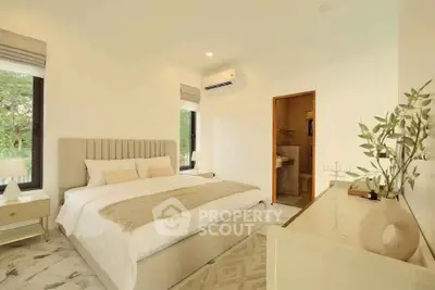 Elegant bedroom with modern decor and ensuite bathroom, featuring large windows and neutral tones.