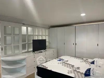 Spacious bedroom with modern furnishings and ample storage space