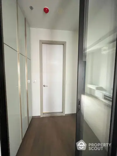 Modern hallway with sleek design and wooden flooring in a contemporary apartment.