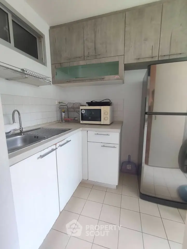 Compact kitchen with modern appliances and ample storage space