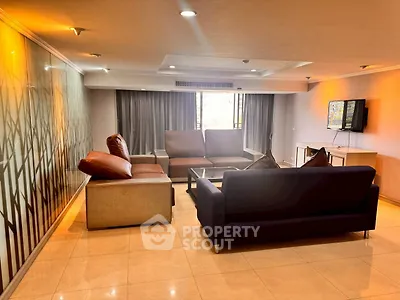 Spacious living room with modern furniture and large windows offering natural light.