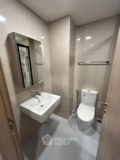 Modern bathroom with sleek fixtures and neutral tiles