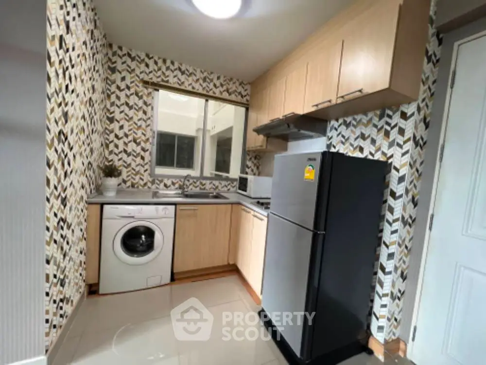 Modern kitchen with washing machine and stylish backsplash