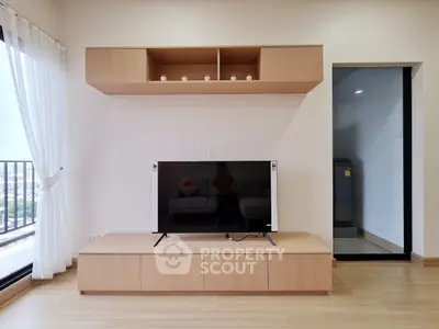 Modern living room with sleek TV unit and balcony view