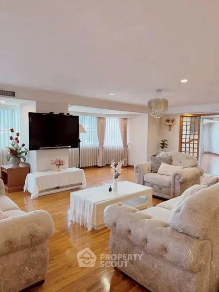 Spacious living room with elegant furniture and large windows for natural light.