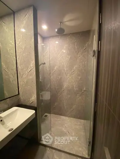 Modern bathroom with sleek shower and elegant marble tiles