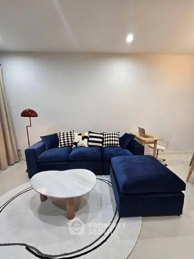 Stylish living room with blue sofa and modern decor