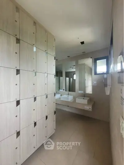 Modern bathroom with sleek sinks and ample storage lockers