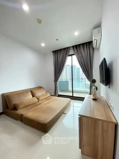Modern living room with sleek furniture and city view balcony