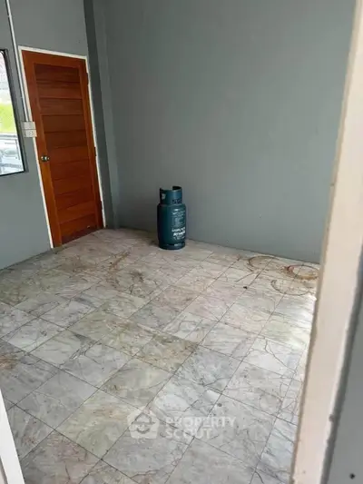 Unfurnished room with marble flooring and a gas cylinder, ready for customization.
