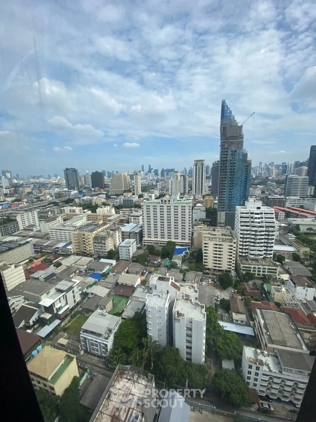 Stunning cityscape view from high-rise building showcasing urban skyline and architectural diversity.