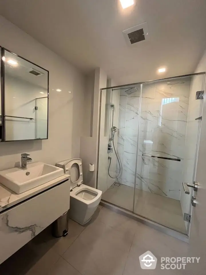 Modern bathroom with glass shower and sleek fixtures