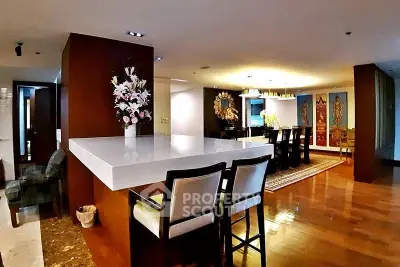 Luxurious open-plan living and dining area with elegant decor and polished wooden floors.