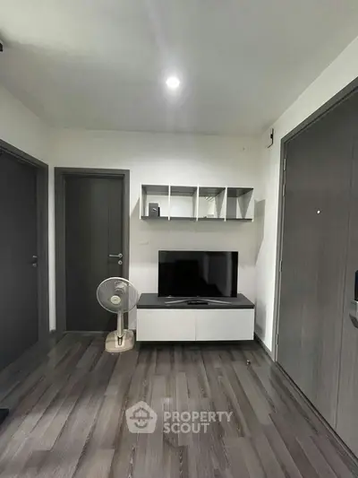 Modern living room with sleek TV stand and stylish shelving, perfect for contemporary living.