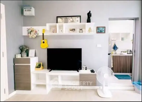 Stylish living room with modern decor and open view into kitchen area