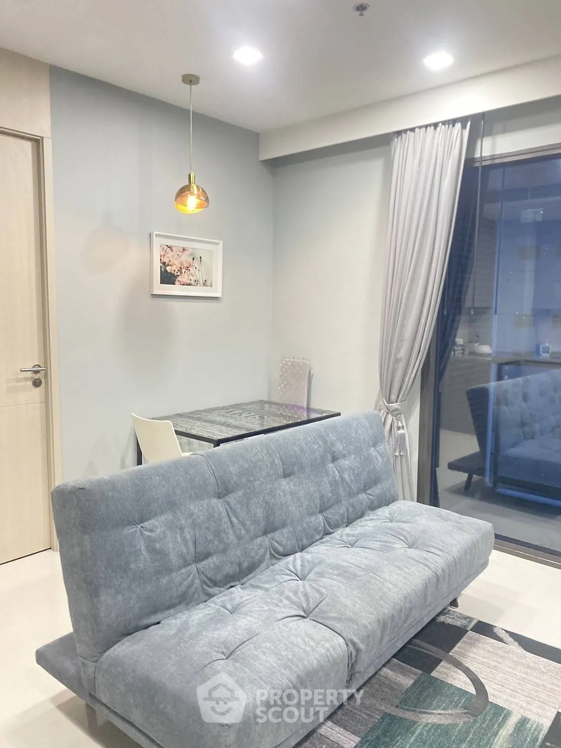 Modern living room with stylish sofa and elegant lighting, perfect for cozy evenings.