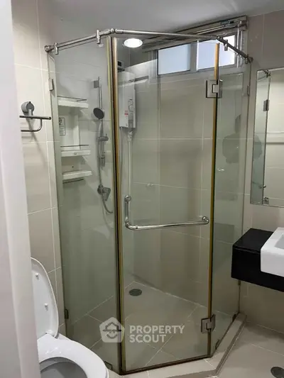 Modern bathroom with glass shower enclosure and sleek fixtures