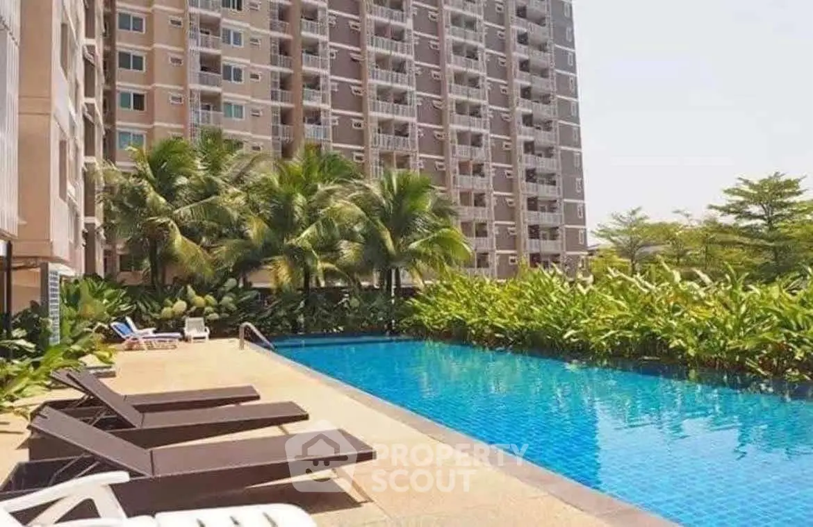 Luxurious apartment complex with a stunning outdoor pool and lush greenery.