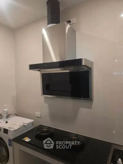 Modern kitchen with sleek gas stove and stainless steel range hood