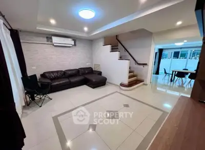 Spacious modern living room with elegant staircase and stylish furniture