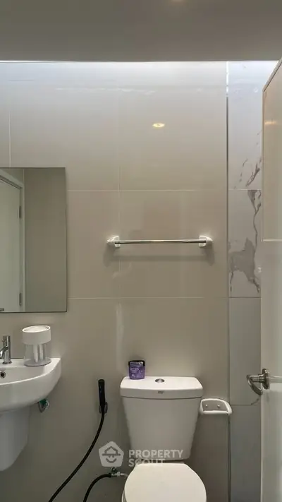 Modern bathroom with sleek fixtures and neutral tiles