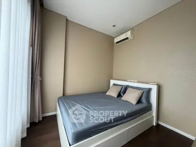 Modern bedroom with sleek design and air conditioning in a high-rise apartment.