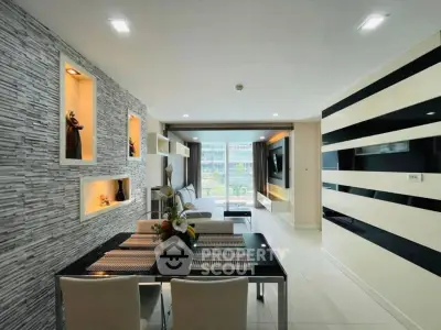 Modern living room with stylish decor and open layout, featuring a dining area and large windows.