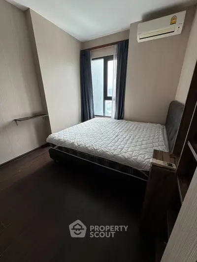 Cozy bedroom with modern design, featuring a comfortable bed and air conditioning, perfect for relaxation.
