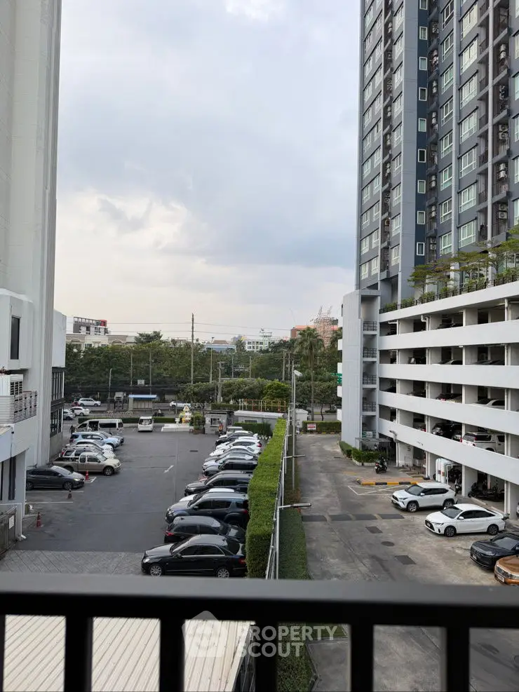 High-rise building with parking lot and city view