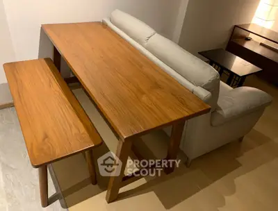 Stylish modern living room with wooden dining table and cozy sofa