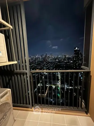 Stunning high-rise balcony with breathtaking city skyline view at night.