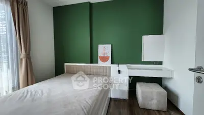 Modern bedroom with green accent wall and minimalist decor
